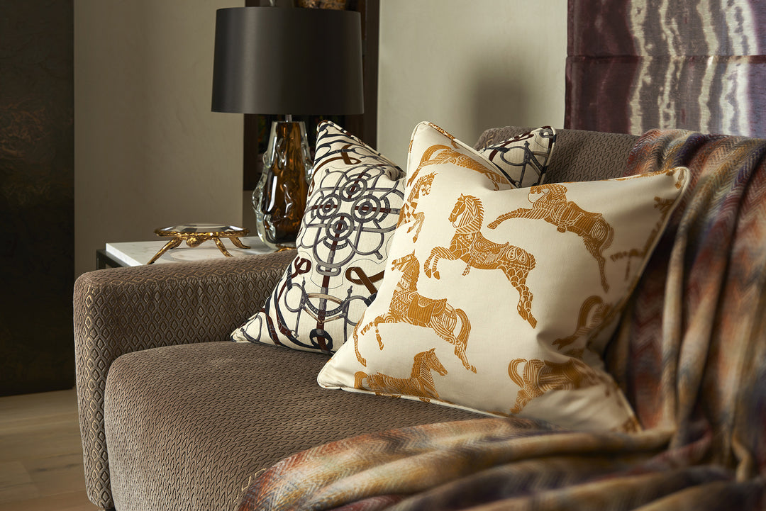 Horse Jacquard Cushion - Lifestyle 1 - Scatter Cushion. Off-white and mustard colours. 2 different fabrics on front and back. Front side is Designer Hermès fabric featuring the iconic Hermès horses embroidery. Back side is luxurious Mustard ultra soft cot