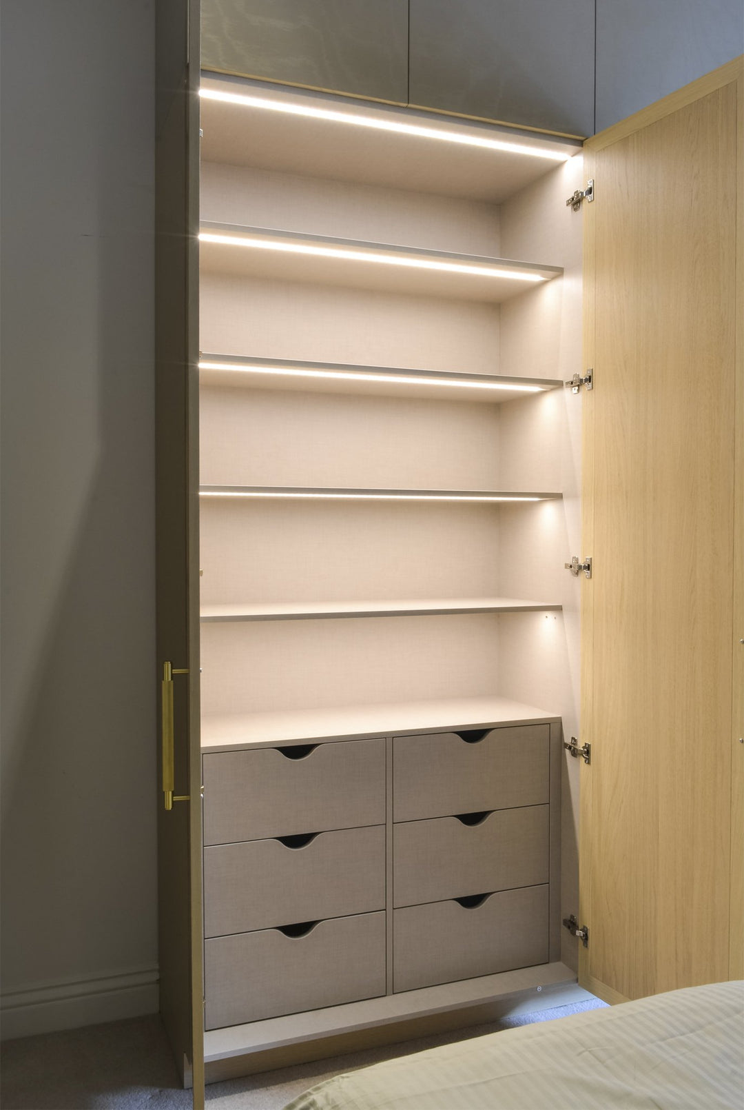 Bespoke Makeup Unit with Wardrobe Space - Wardrobe Interior - Fitted Wardrobe. Built-in dressing table. Design, manufacture and installation service. Wardrobe doors include inset clear mirror with bevelled edges. Wardrobe door frames made from Oak veneere