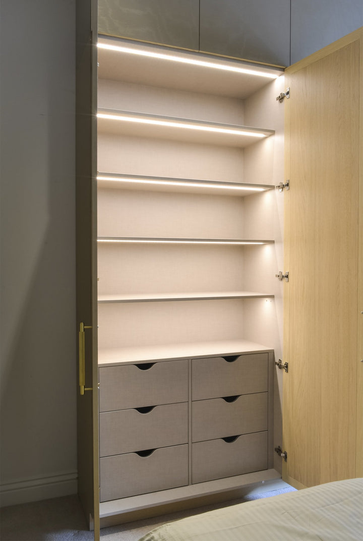 Bespoke Makeup Unit with Wardrobe Space - Wardrobe Interior - Fitted Wardrobe. Built-in dressing table. Design, manufacture and installation service. Wardrobe doors include inset clear mirror with bevelled edges. Wardrobe door frames made from Oak veneere