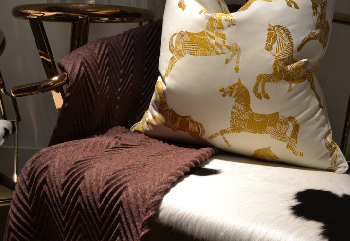 Horse Jacquard Cushion - Lifestyle 2 - Scatter Cushion. Off-white and mustard colours. 2 different fabrics on front and back. Front side is Designer Hermès fabric featuring the iconic Hermès horses embroidery. Back side is luxurious Mustard ultra soft cot