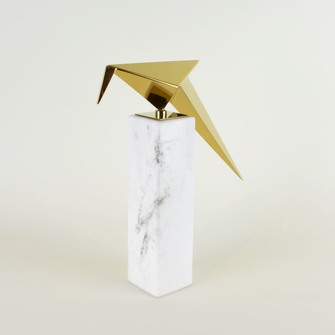 Leaning Origami Bird - View 1 - Contemporary Decorative Object. Inspired by the Japanese origami art. Gold colour ornament with Calacatta marble base. Origami Bird Sculpture. Materials: Nickel plated steel, Calacatta marble. Bird theme home accessories. M