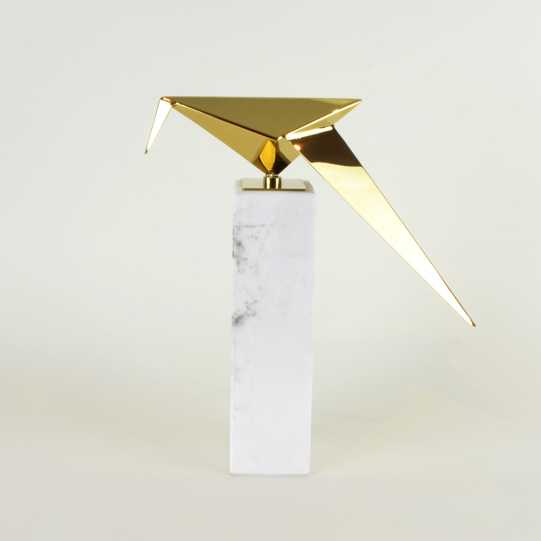 Leaning Origami Bird - View 2 - Contemporary Decorative Object. Inspired by the Japanese origami art. Gold colour ornament with Calacatta marble base. Origami Bird Sculpture. Materials: Nickel plated steel, Calacatta marble. Bird theme home accessories. M