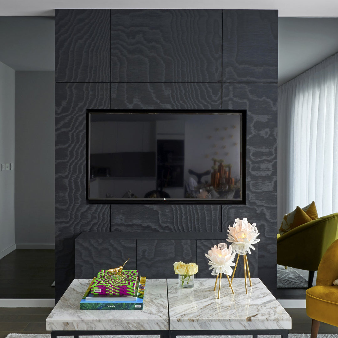 Black Textured TV Unit - Front View - Fitted TV Unit. Bespoke Media Unit. Design, Manufacture and Installation service. Black colour. Black Moire cladding for textured finish. Shadow gap detail for for joining unit panels. 65" TV Inset into the bespoke bl