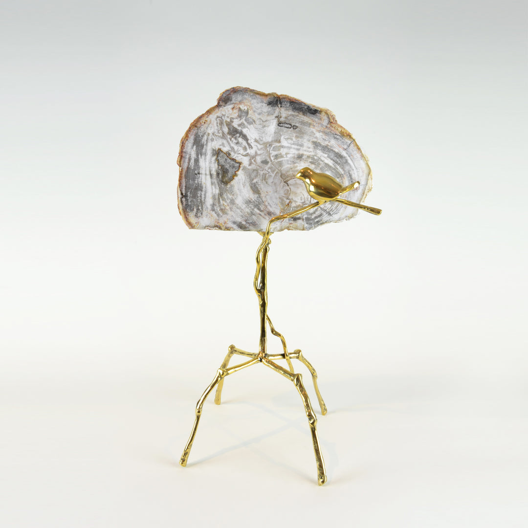 Petrified Bird Sculpture - View 2 - Brass Sculpture / Decorative Object. Bird sculptural detail. Gold, grey and taupe colours. Petrified Wood slice. Materials: Brass, Petrified Wood. Dimensions: W27(OA) D20 H50cm. Bird and nature theme home accessories. Animal Ornament. Designer gift. large size sculpture for styling shelves, display units, niches and console tables.